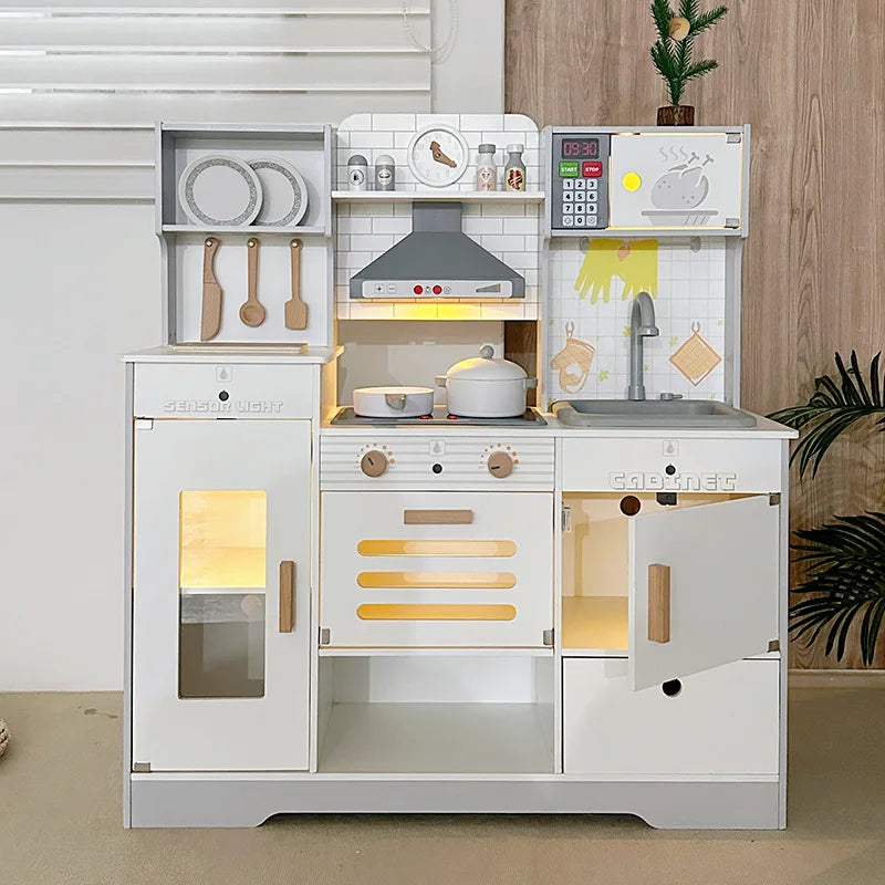 White wooden play kitchen with hood, microwave and sink