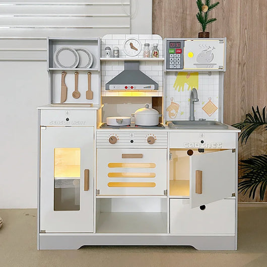 White wooden play kitchen with hood, microwave and sink